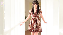 Standing in hall wearing brown dress long hair