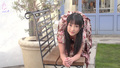 Reina on all fours on garden bench long hair wearing brown dress