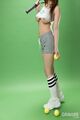 Standing holding tennis racquet wearing crop top big breasts in socks