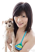 Holding dog wearing bikini top